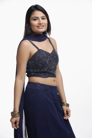 Woman in traditional Indian outfit, smiling at cameraの写真素材