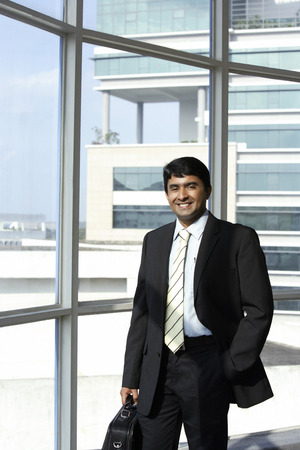 business man holding briefcase, smilingの写真素材