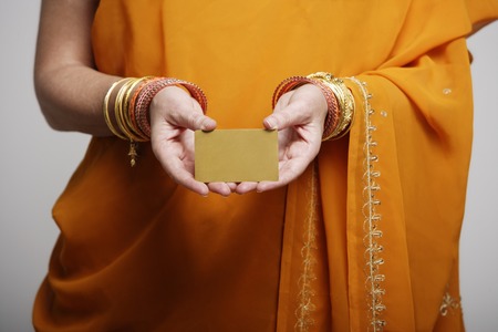 cropped shot of woman wearing sari holding credit cardの写真素材