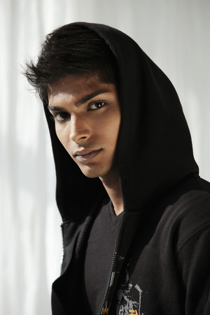 Head shot of young man wearing a hoodの写真素材