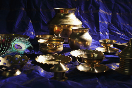Still life of Indian brass bowls and cups on tableの写真素材