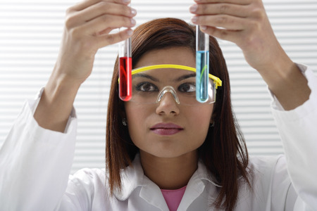 Scientist with holding two vilesの写真素材
