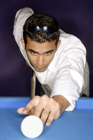 Young man playing pool, portrait