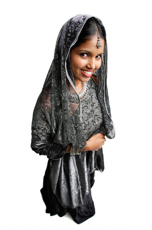 Woman in gray sari standing against white backgroundの写真素材