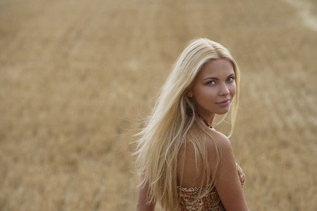Young woman looking back over shoulderの写真素材