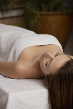 Young woman lying on massage tableの写真素材