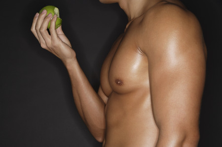 muscular man with appleの写真素材