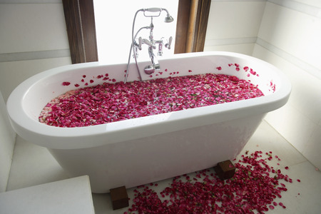 bath tub with floating petalsの写真素材