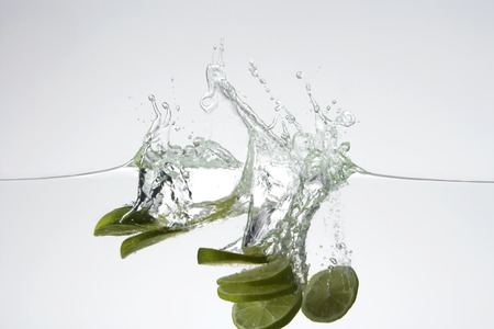 slices of lime in waterの写真素材