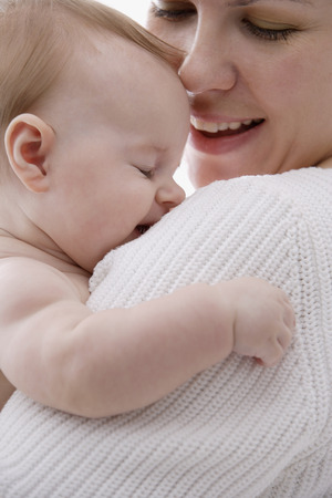 Baby on mother's shoulderの写真素材