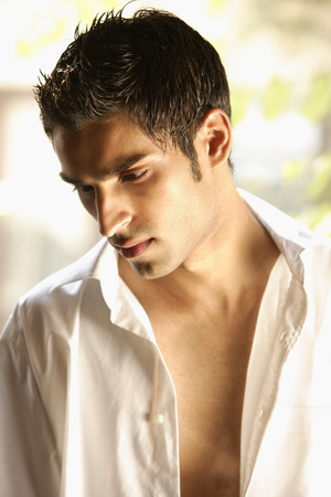 Profile of man with unbuttoned white shirt onの写真素材