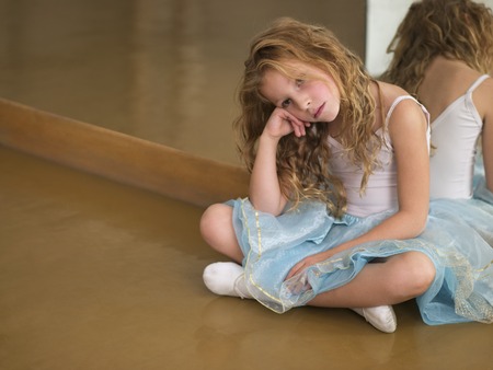 young ballerina sitting in studioの写真素材
