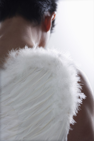 Close up of man with angel wingsの写真素材