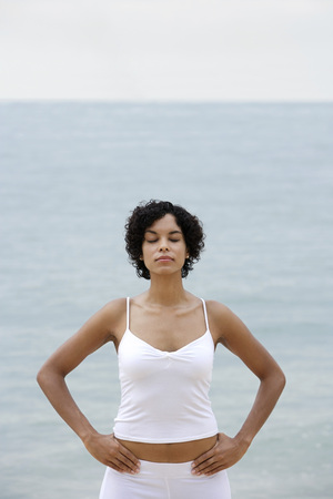 woman relaxing on beach, eyes closedの写真素材