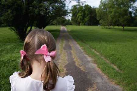 young girl with pink bows in her hairの写真素材