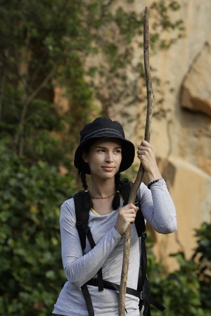 Young woman with walking stickの写真素材