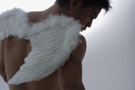 Man wearing angel wingsの写真素材