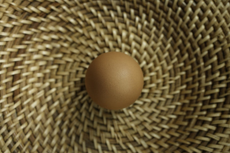 Brown egg in basketの写真素材