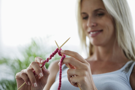 head shot of woman knittingの写真素材