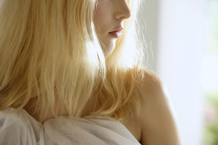 close up profile of woman's mouth, chin, shoulderの写真素材