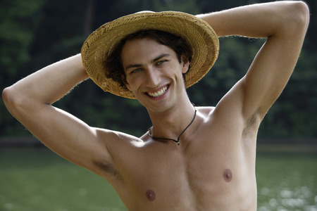 Young man wearing hat, smilingの写真素材