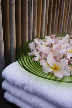 Still life of towels and plate of flowersの写真素材
