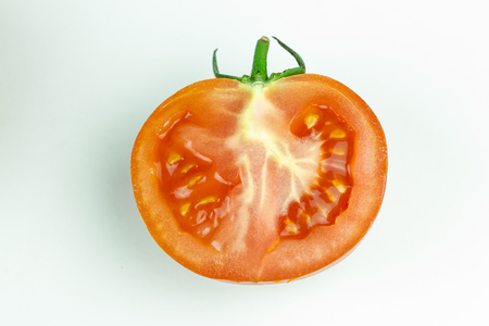Tomatoes. Whole and a half isolated on whiteの写真素材