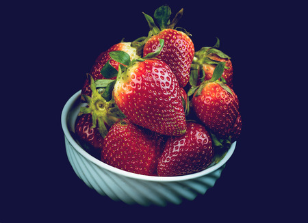 Half of strawberry isolated on black backgroundの写真素材