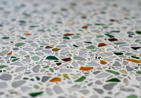 Modern Recycled Glass Terrazzo Texture Reflecting Sharp Sunlight, Extreme Close-up.