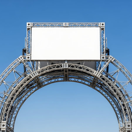 Empty exhibition entrance arch with plain white signage and metal truss construction.