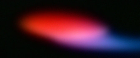 Abstract background. Multi-colored spots of light on a black background.