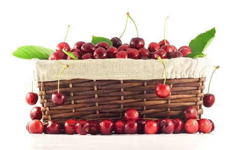 Beautiful cherries in basket surrounded by another cherriesの写真素材