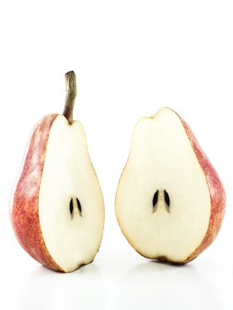 Two halfs of a pear with pits on a white backgroundの写真素材
