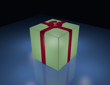 Green gift box wrapped in red ribbon, on blue and black background.の写真素材