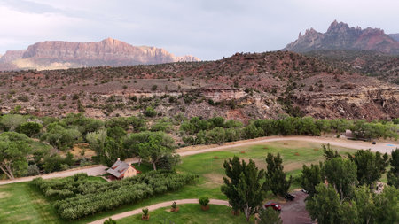 Aerial view of Rocky Mountains in Utah, USA, with contrasting greenery in the foregroundの写真素材