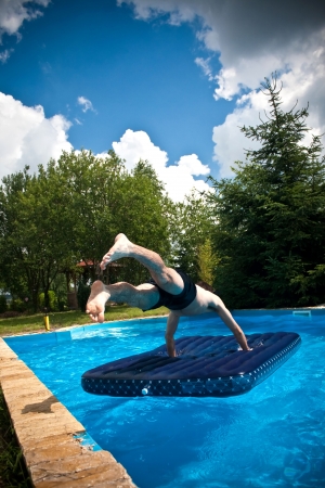 man jumping into the swimming pool, mattressの写真素材