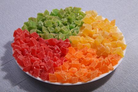 Pineapple slices on the plate. Four colours separately. Candied fruit.の写真素材