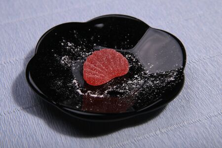 Plates with sweets. Marmalade on the dish. Black dishes. Marmalade slices.の写真素材