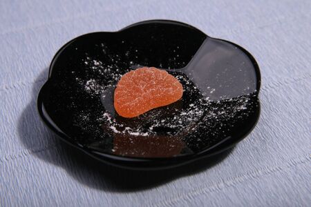 Plates with sweets. Marmalade on the dish. Black dishes. Marmalade slices.の写真素材