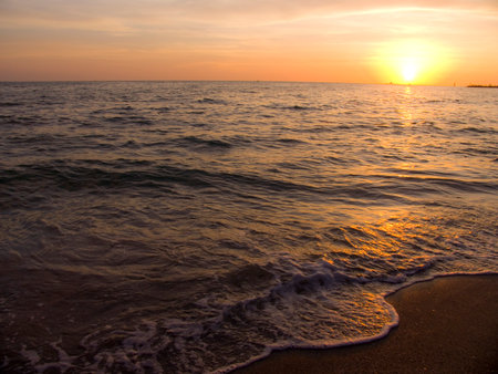 Light sunset rays falling on the wavesの写真素材