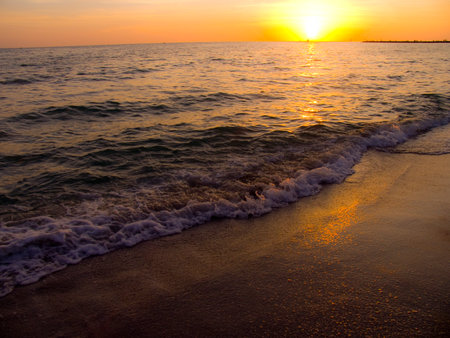 Light sunset rays falling on the wavesの写真素材