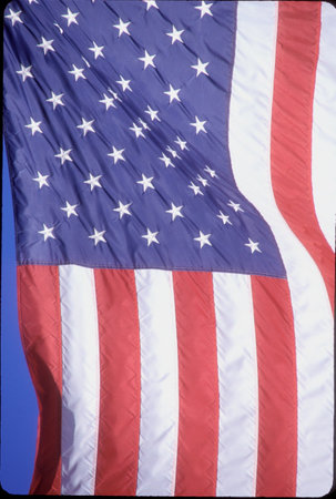 American flag flying in the skyの写真素材
