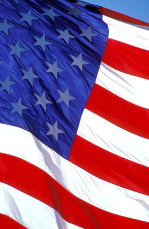 American flag flying in the skyの写真素材