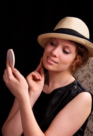 beautiful young woman applying her makeupの写真素材