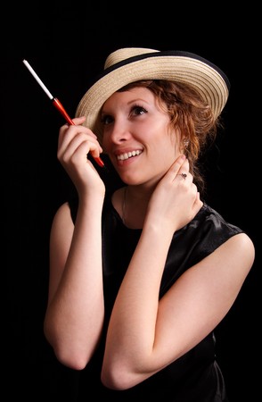 young woman with a cigarette on a black backgroundの写真素材