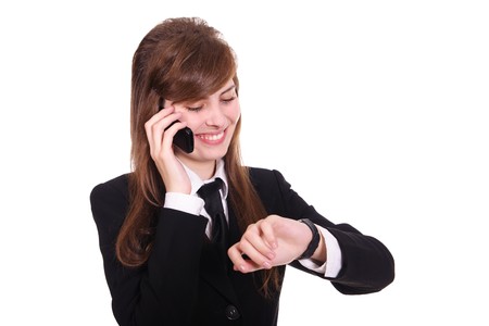 business women speaks by phone and looks at the wrist watchの写真素材