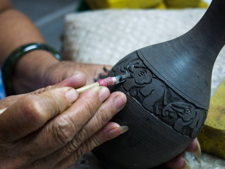 Artisan carving a clay with handsの写真素材
