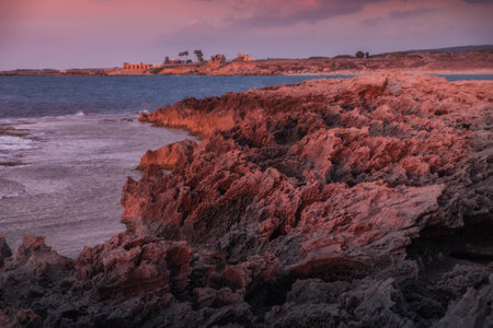 Rocky coastline in the light of sundownの写真素材