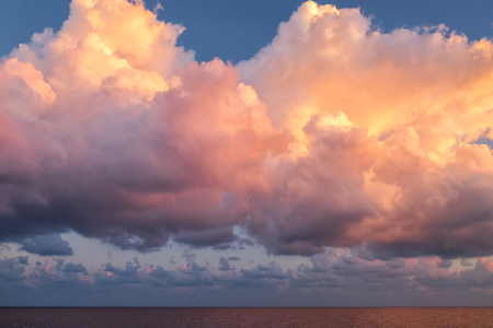 Cloudscape in dramatic pink and yellow lightの写真素材