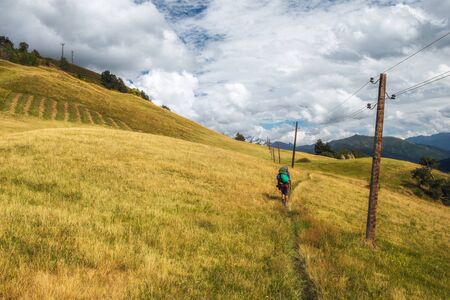 Autumn day in Svaneti mountains with tourist hikingの写真素材